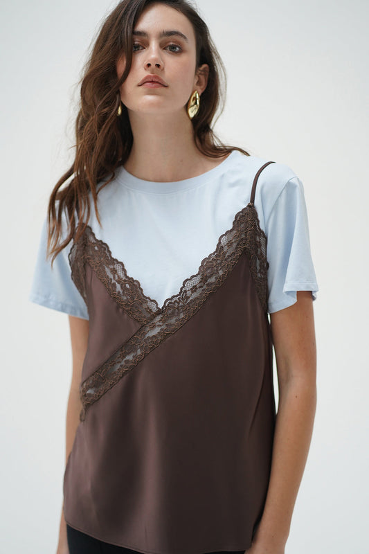 Woman wearing a cacao and blue Rowan cami layer tee, made of soft fabric, shown against a plain background.