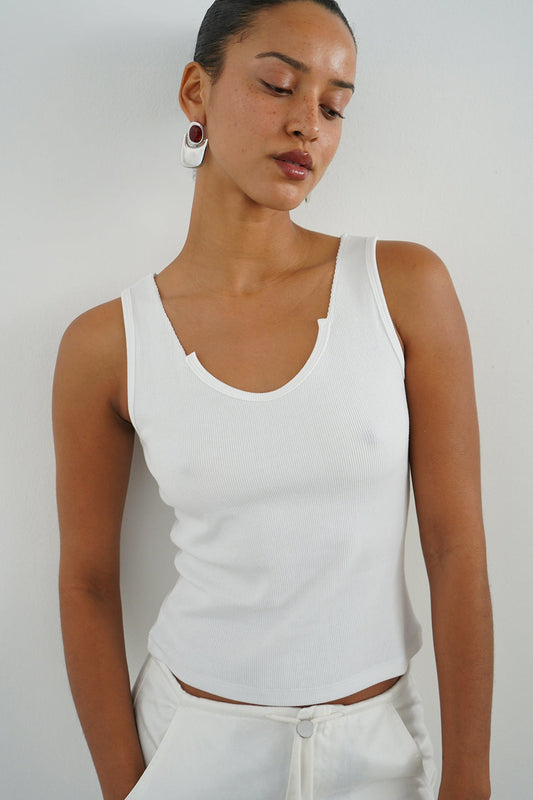 Woman wearing a white ribbed tank top