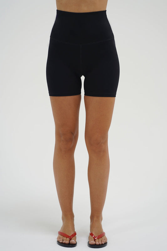 Woman wearing black high-waisted fitted athleisure shorts 