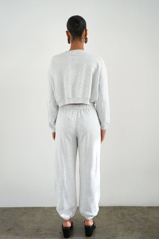 Woman wearing a grey cropped sweatshirt 
