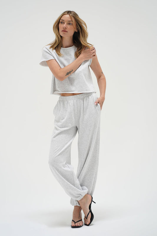 Woman wearing a light heather grey short sleeve sweatshirt