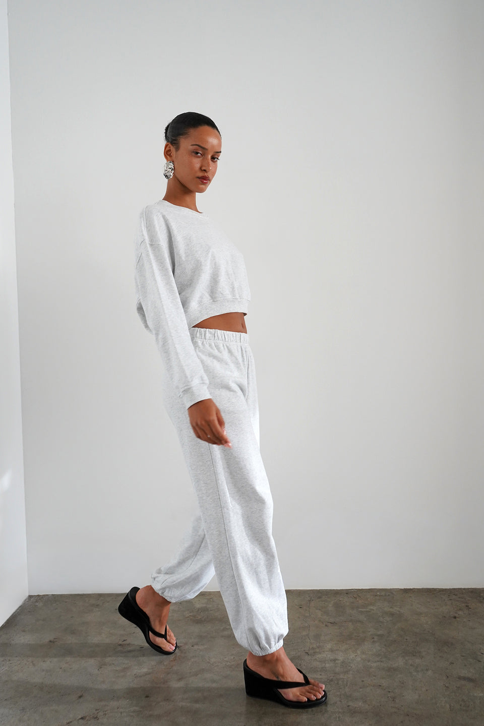 Woman wearing light heather grey sweatpants