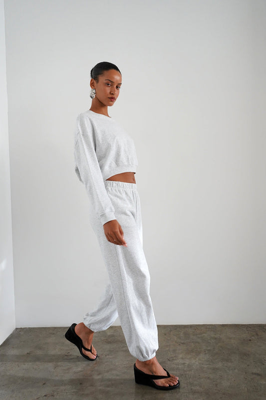 Woman wearing light heather grey sweatpants