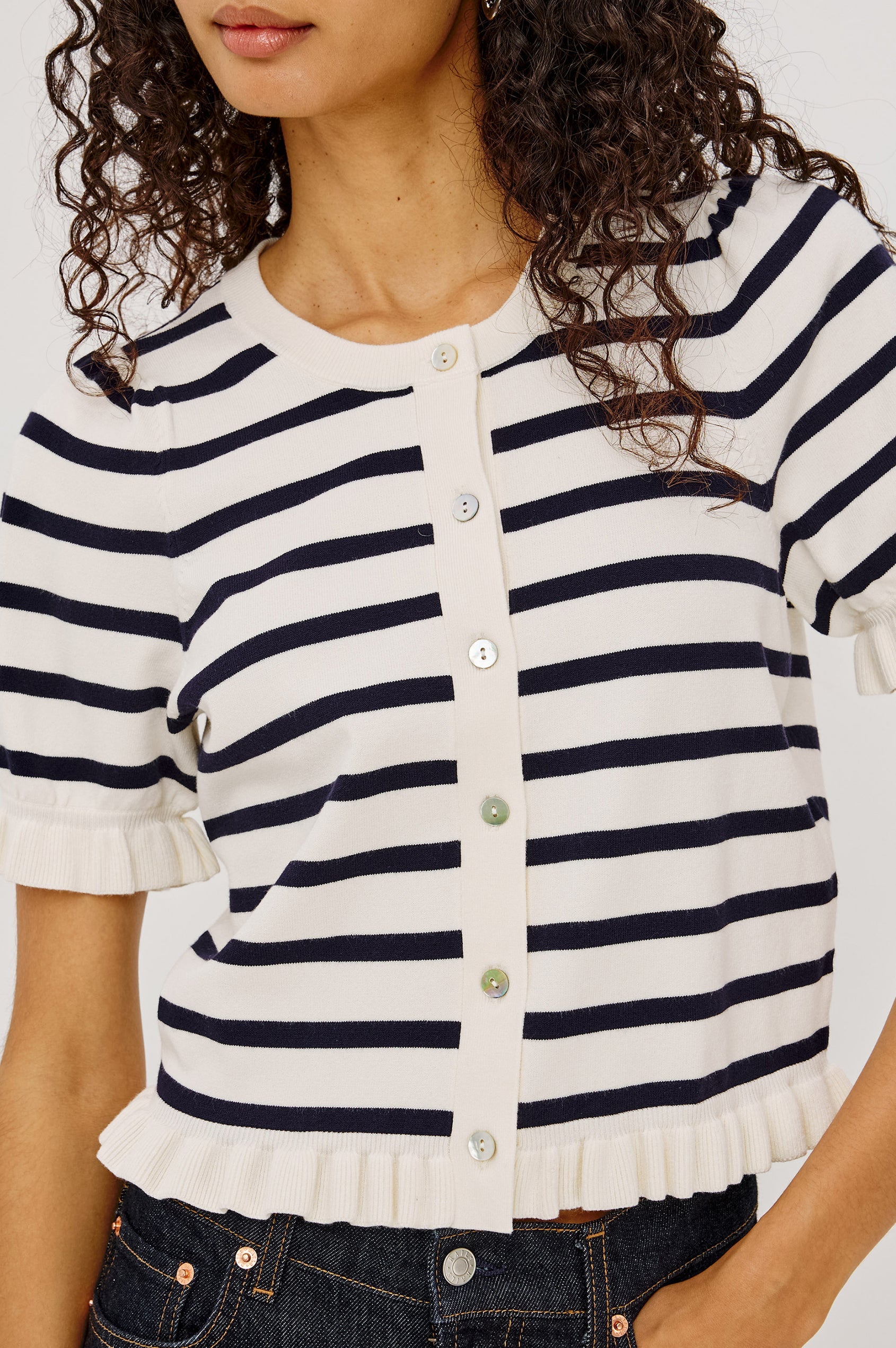 Woman in a navy and white striped button up top