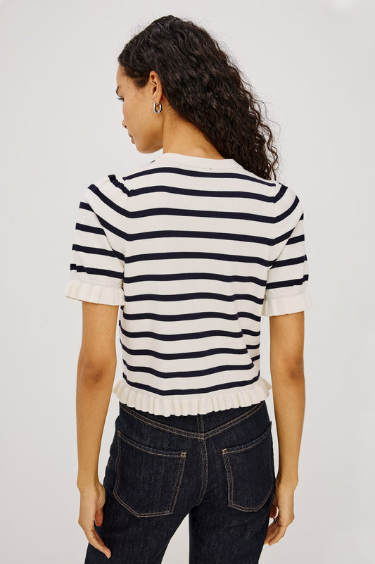 Woman in a navy and white striped button up top