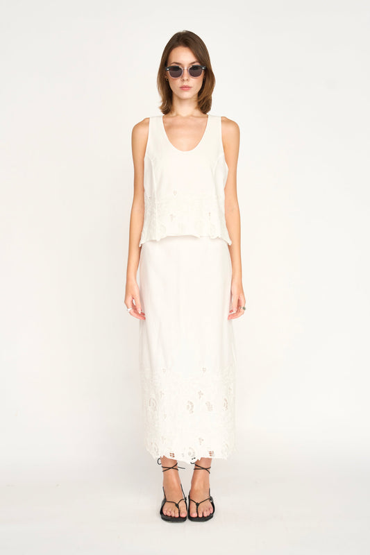 Woman in a white embroidered skirt