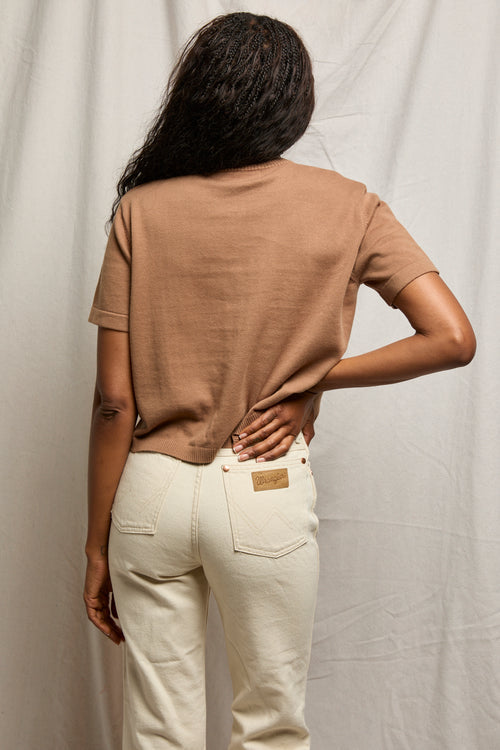 Woman wearing a mocha cotton short-sleeve cardigan, ideal for layering.