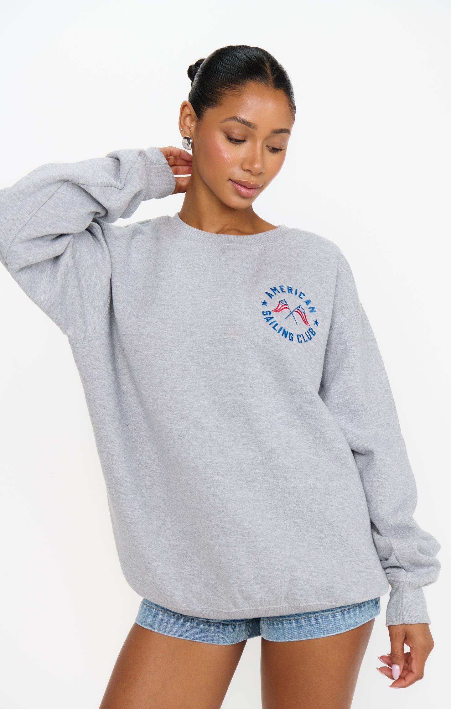 Woman in a graphic grey sweatshirt