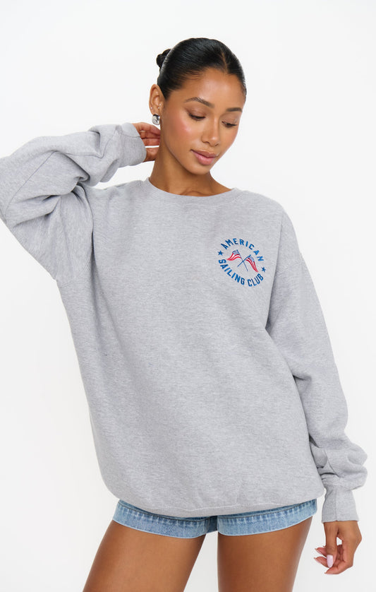 Woman in a graphic grey sweatshirt