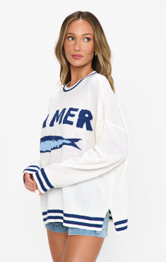 Woman in a white and blue graphic sweater