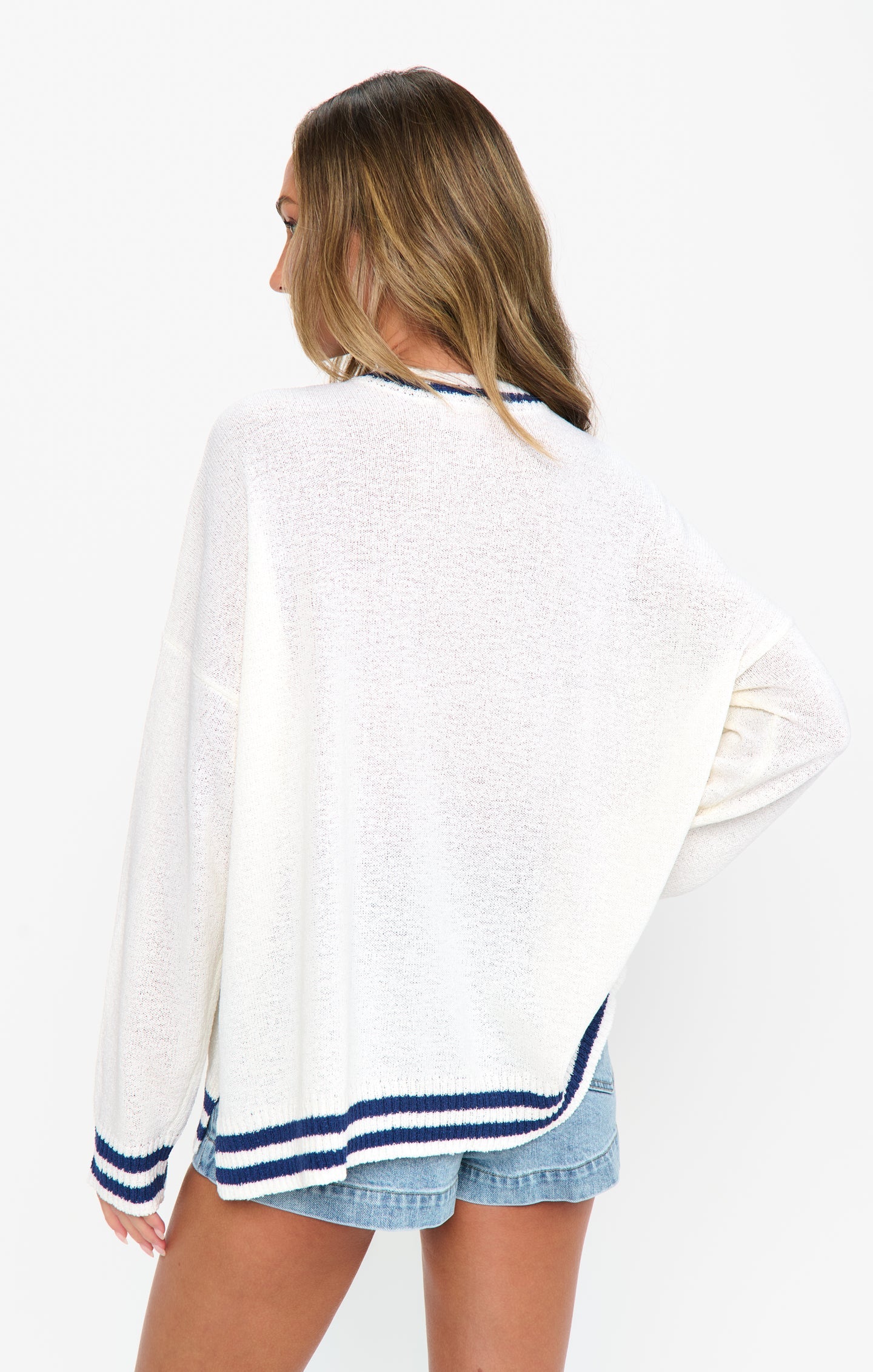 Woman in a white and blue graphic sweater