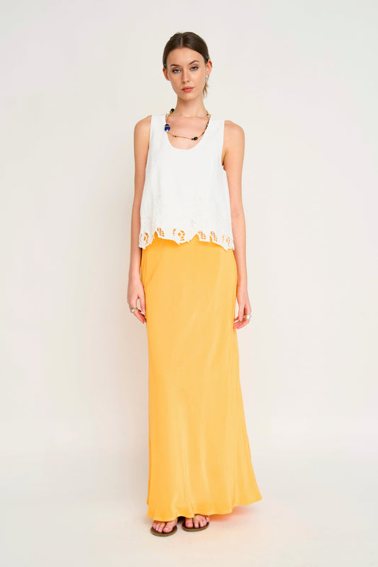 Woman in a white embroidered top