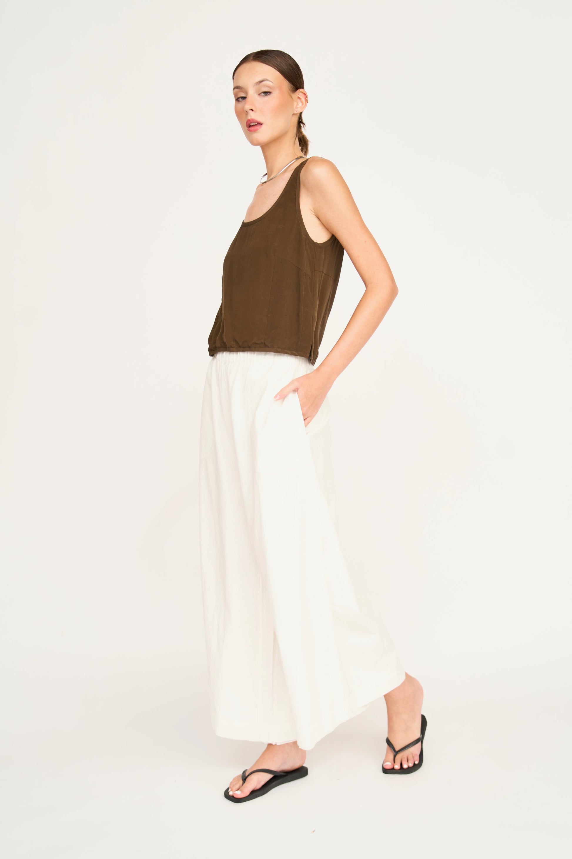 Woman wearing white pants