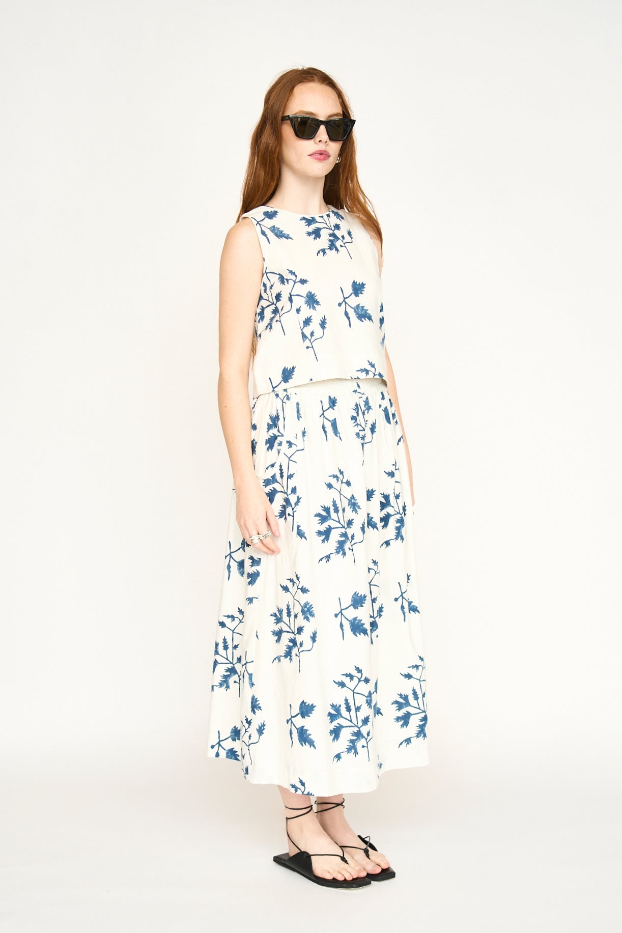 Woman in a white and floral blue top
