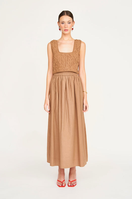 Tan cotton smocked top with textured bodice, ideal for casual wear, shown against a plain white background.