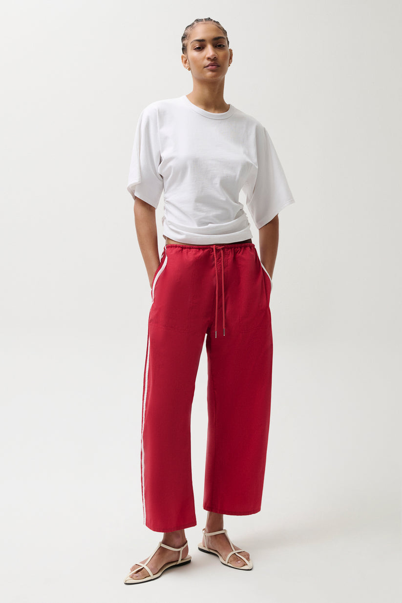 Woman wearing red pants with white stripes