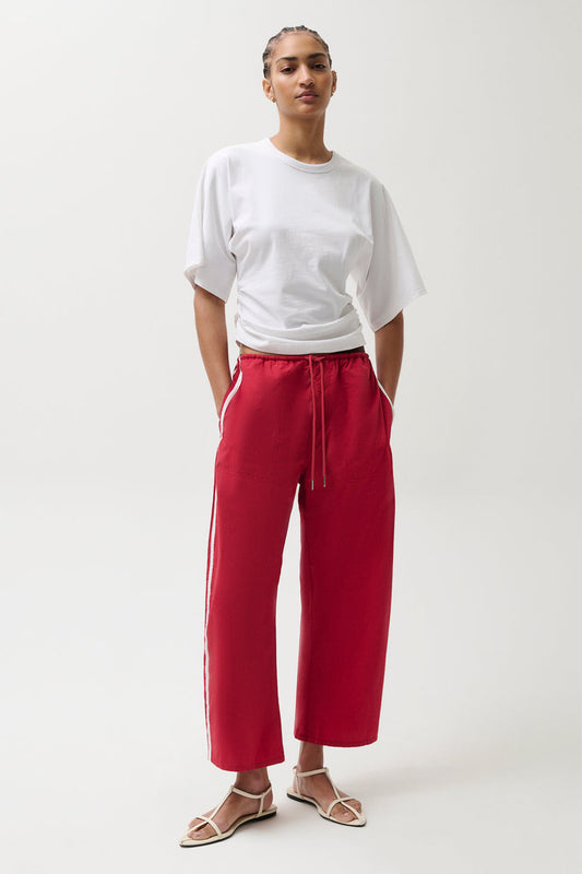 Woman wearing red pants with white stripes