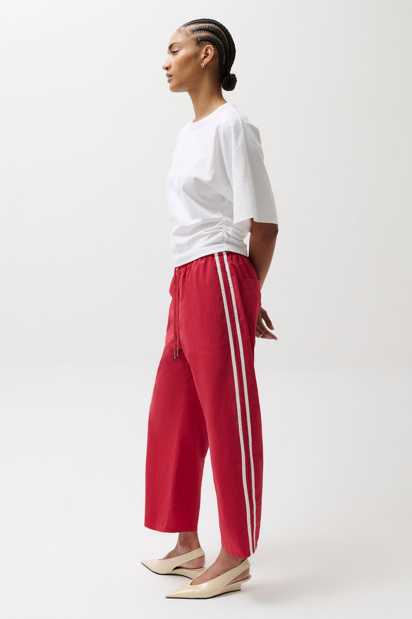 Woman wearing red pants with white stripes
