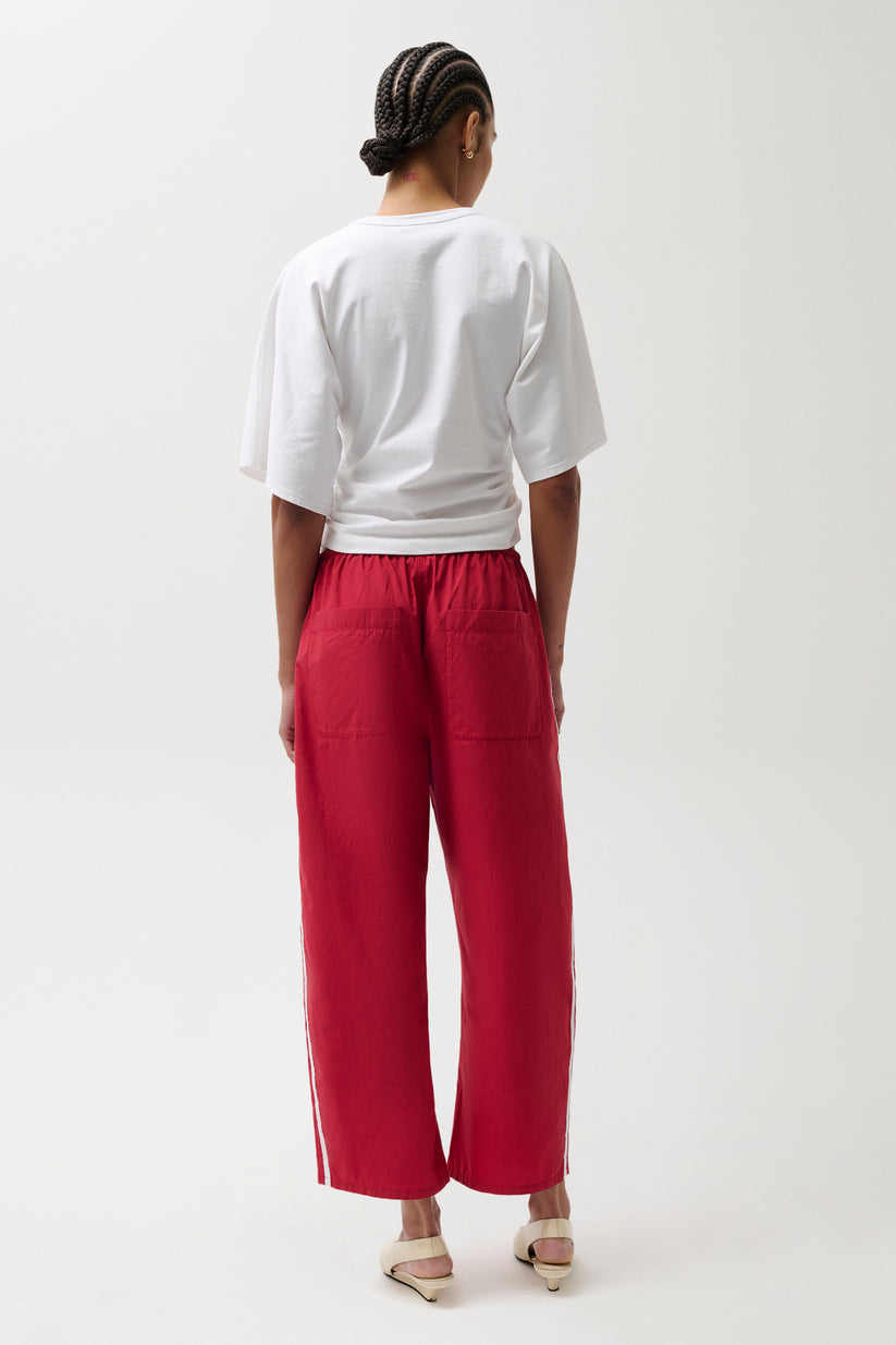 Woman wearing red pants with white stripes