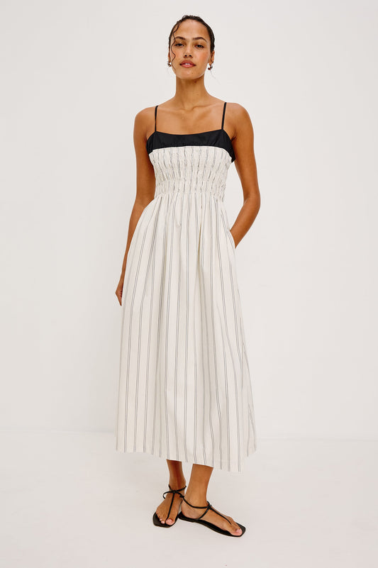 Sleeveless ankle-length white dress with black stripes, lightweight fabric, suitable for warm weather wear.