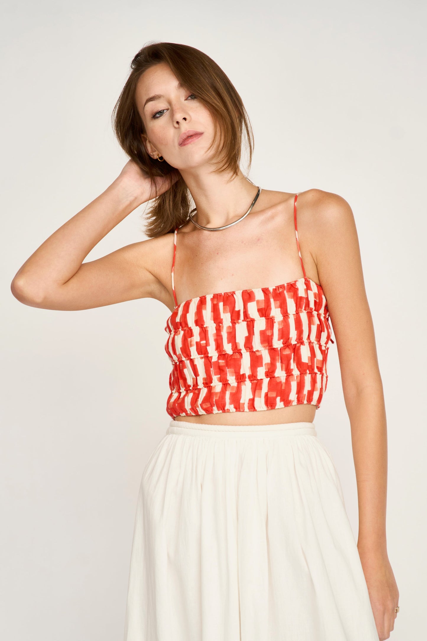 Woman wearing a red and white patterned top 