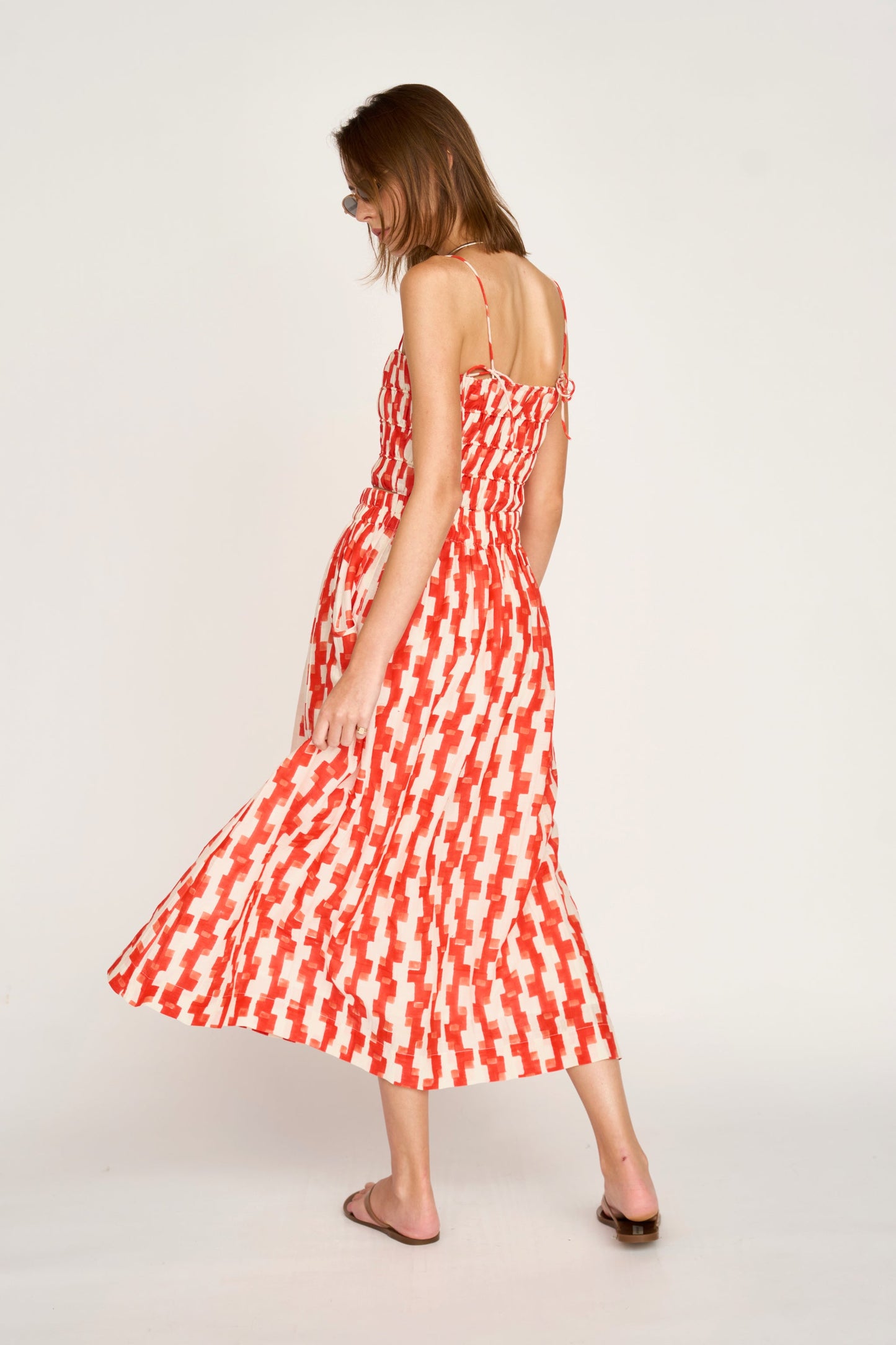 Woman wearing a red and white patterned top 