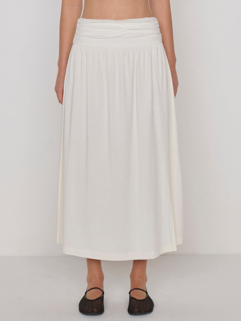 A woman modeling a cream-colored midi skirt