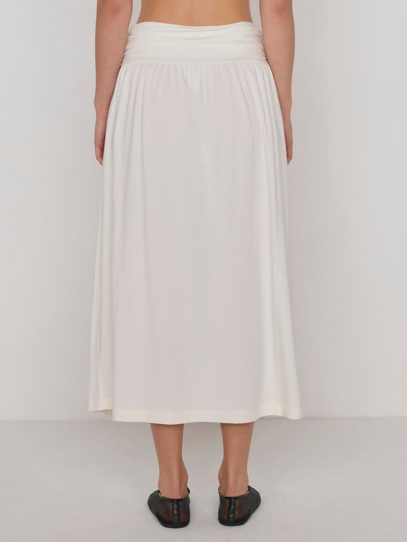 A woman modeling a cream-colored midi skirt