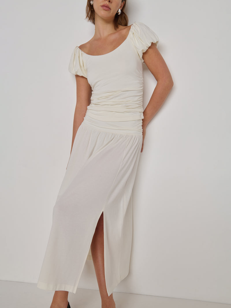A woman modeling a cream-colored midi skirt