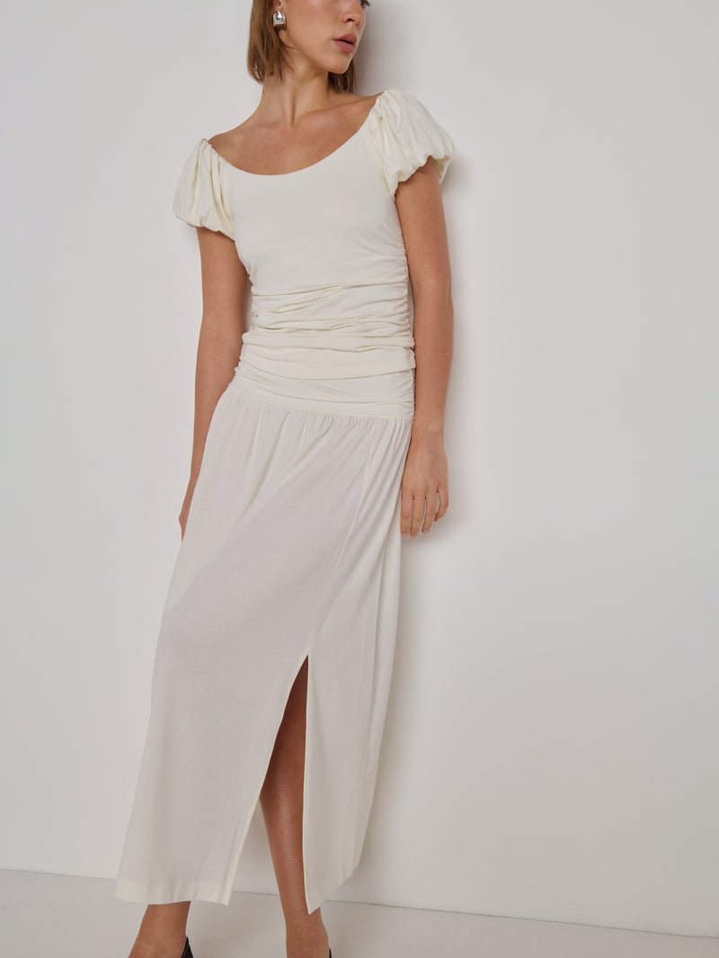 A woman modeling a cream-colored midi skirt