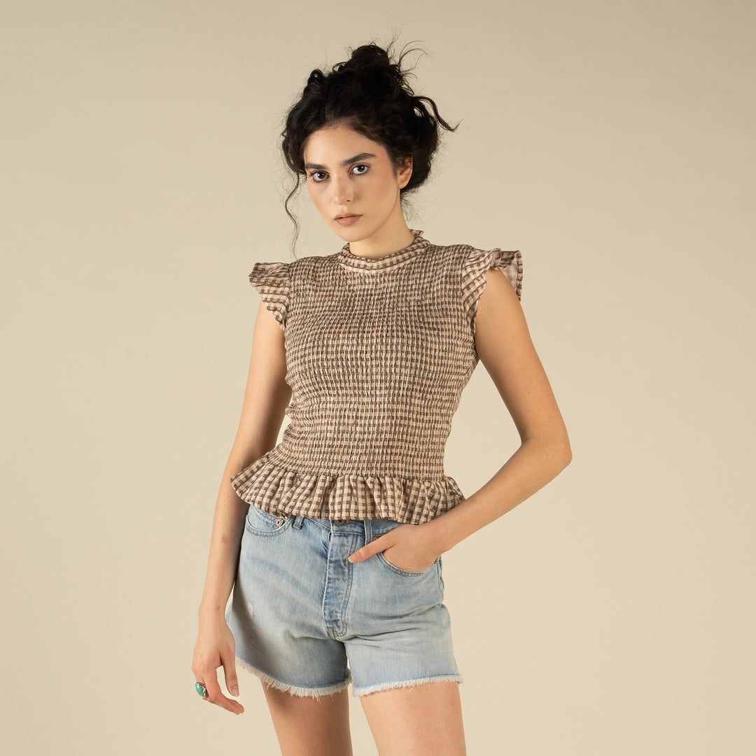 Woman wearing a brown and cream patterned top