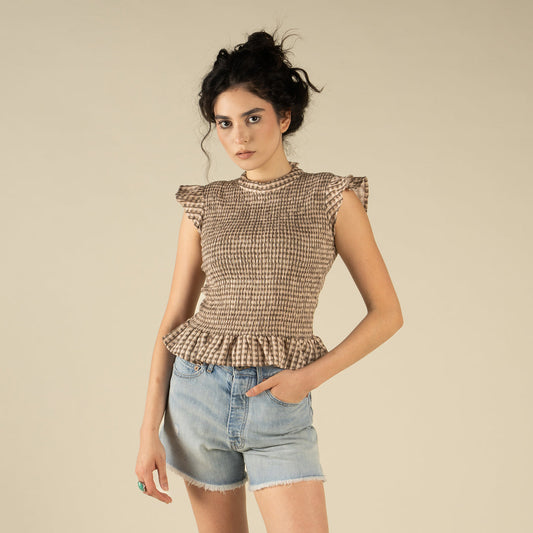 Woman wearing a brown and cream patterned top