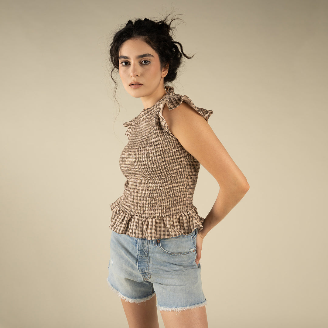 Woman wearing a brown and cream patterned top