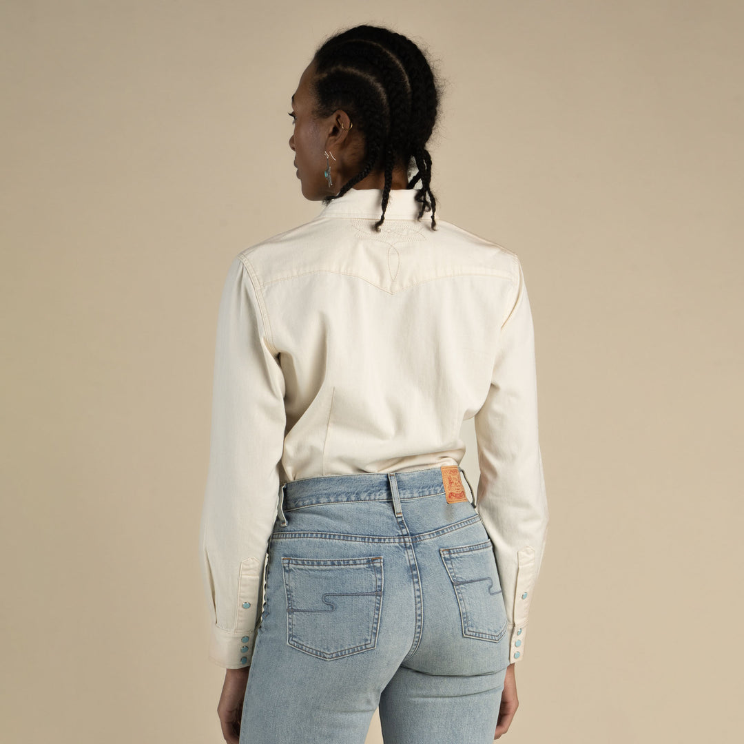 Women wearing a white button up shirt with pearl snaps