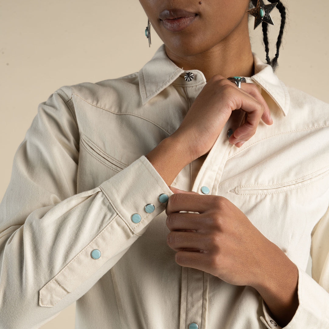 Women wearing a white button up shirt with pearl snaps