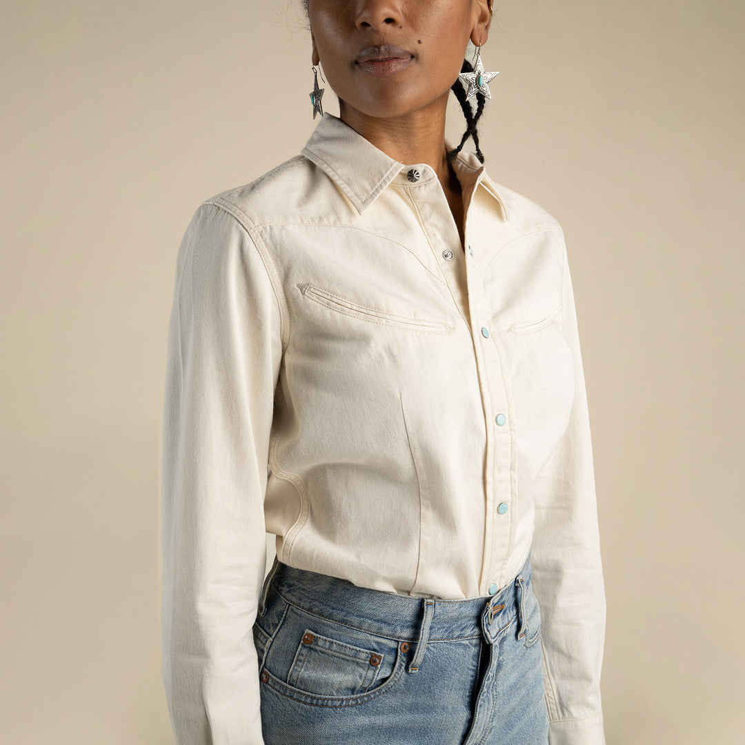 Women wearing a white button up shirt with pearl snaps
