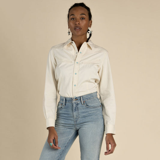 Women wearing a white button up shirt with pearl snaps