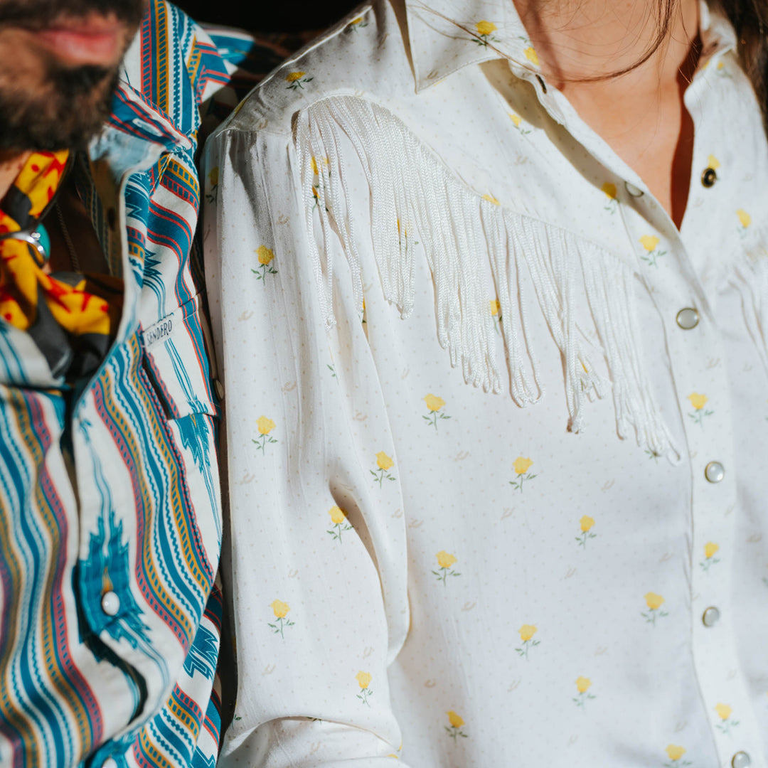Two people sit together; one wears a Texas Rose print womens blouse made of lightweight fabric, suited for casual use.