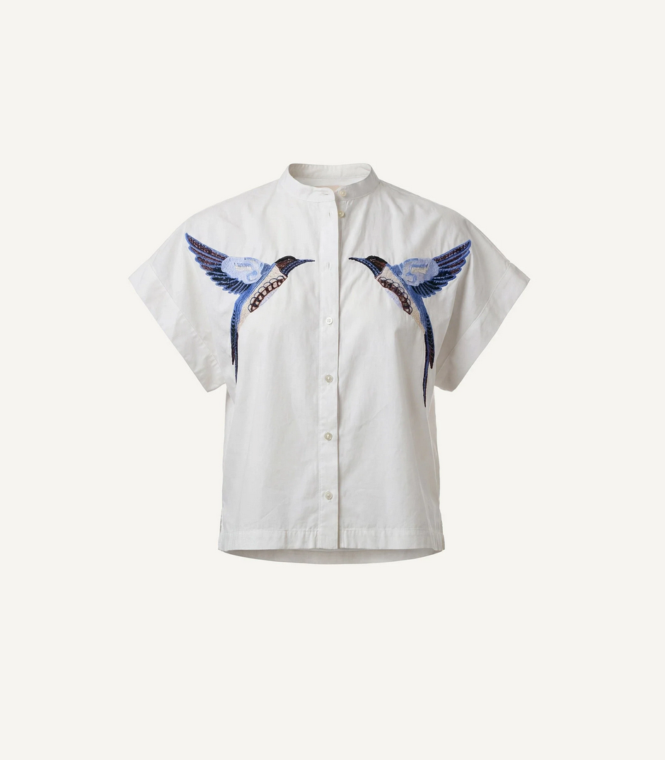 White short-sleeve blouse with two blue and black embroidered birds on the chest, suitable for casual wear.