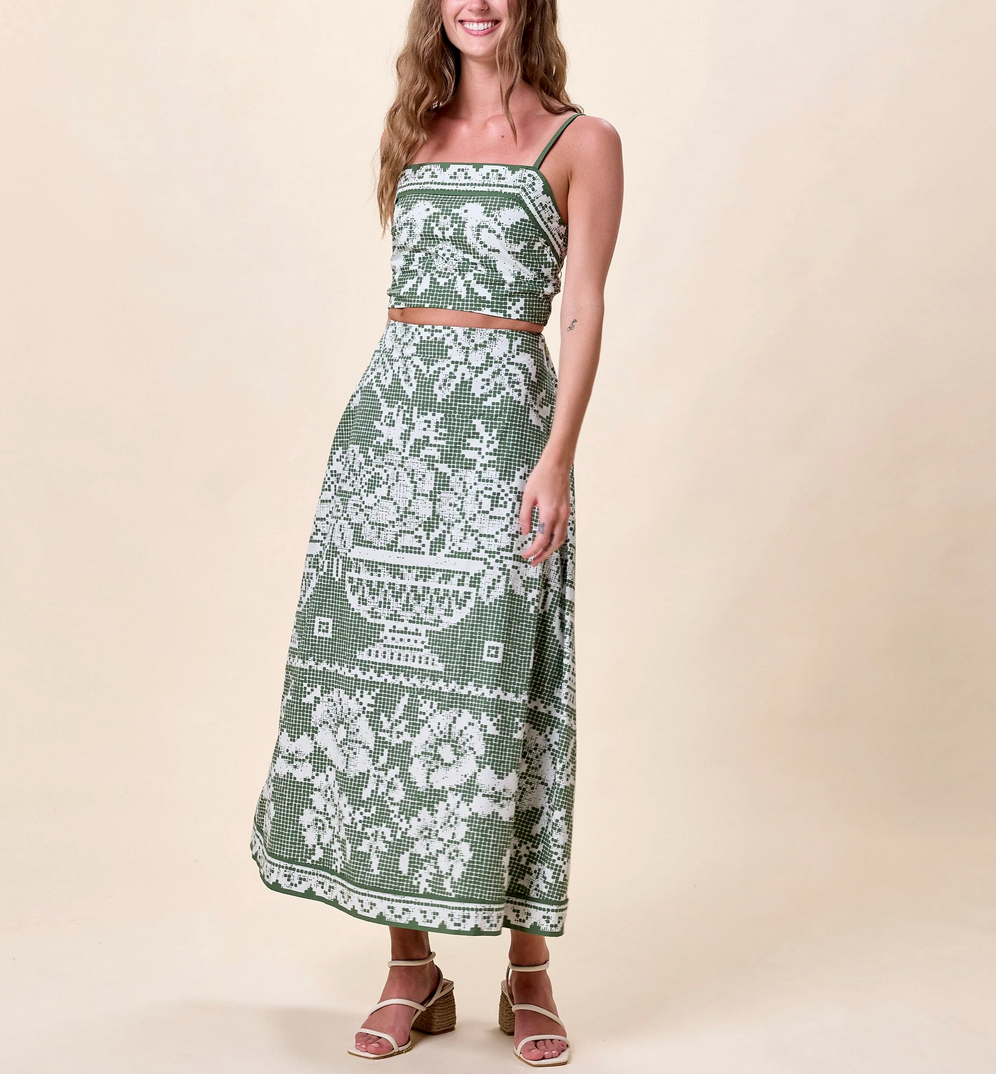 Woman in a green floral organic cotton ankle skirt, smiling. Skirt is lightweight, handmade, and casual.
