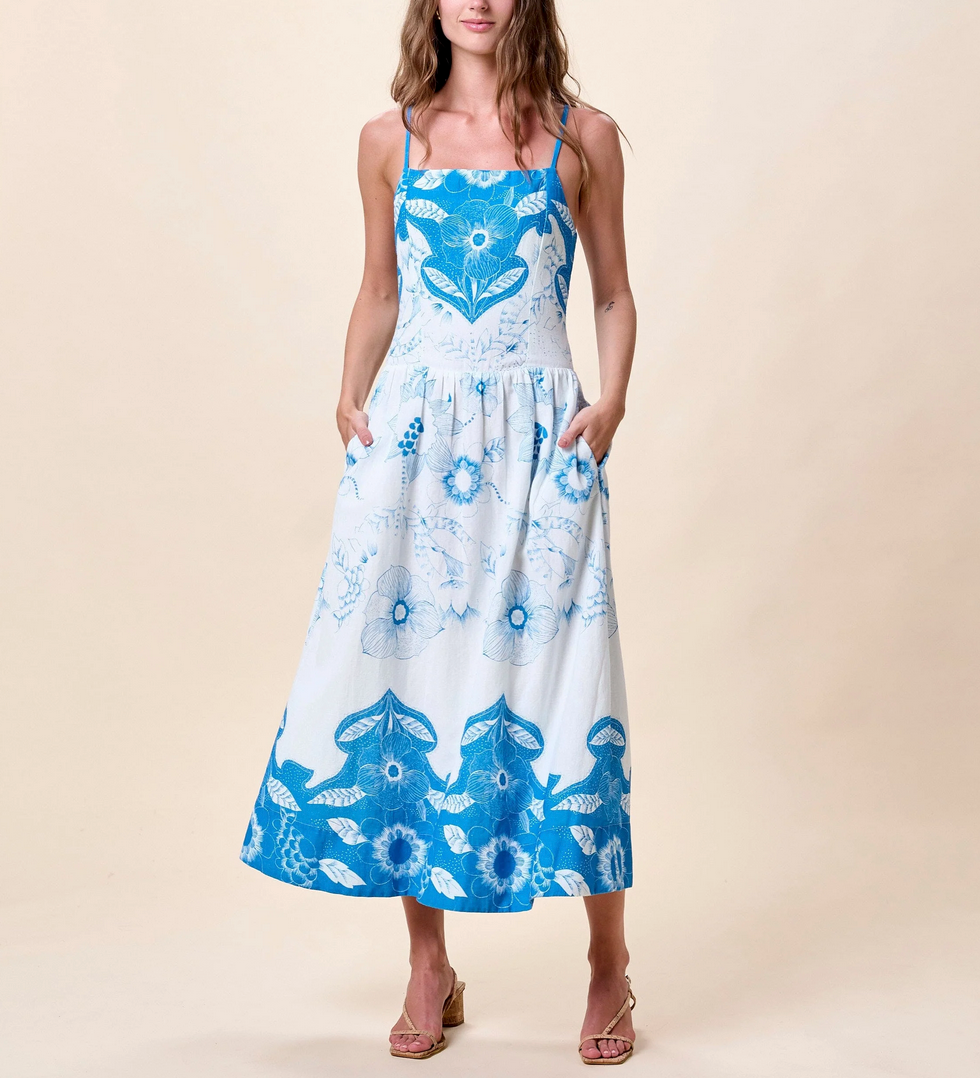Woman wearing a blue and white floral dress