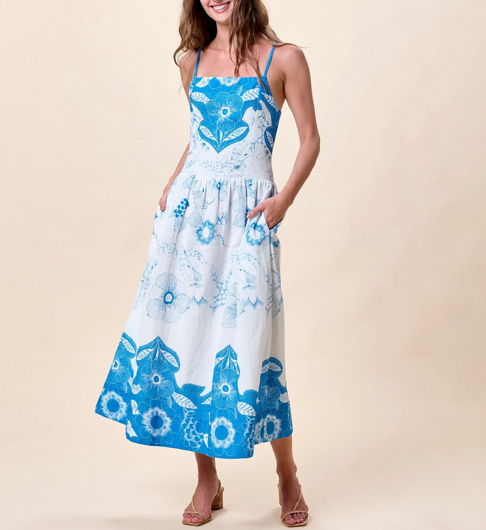 Woman wearing a blue and white floral dress