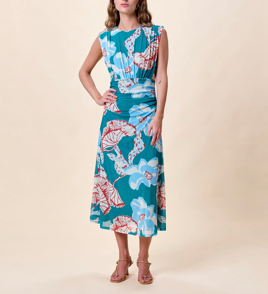 Woman in a red and blue printed midi dress with sandals, suitable for casual or semi-formal occasions.