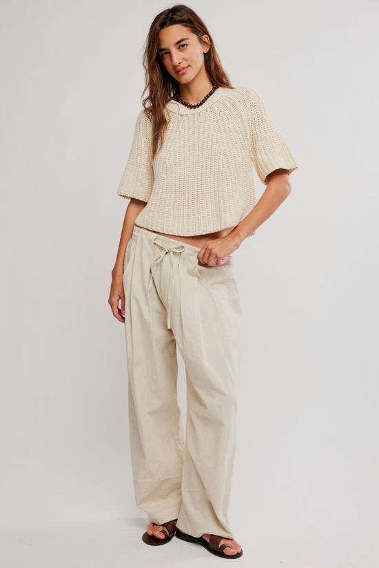 Cream knit top and sand-colored pull-on pants, paired with sandals, shown on a white background.