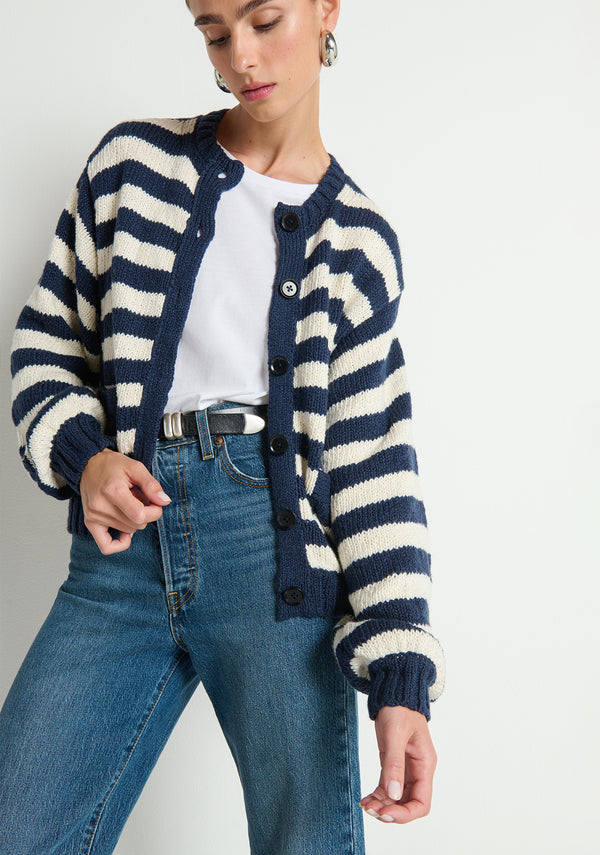 Marine striped cardigan layered over a white T-shirt and blue jeans, showcasing a classic casual look.