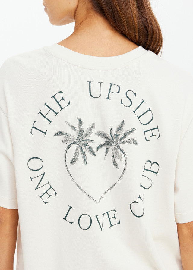 Cream organic cotton tee featuring a palm heart graphic and text on the back. Suitable for casual wear.