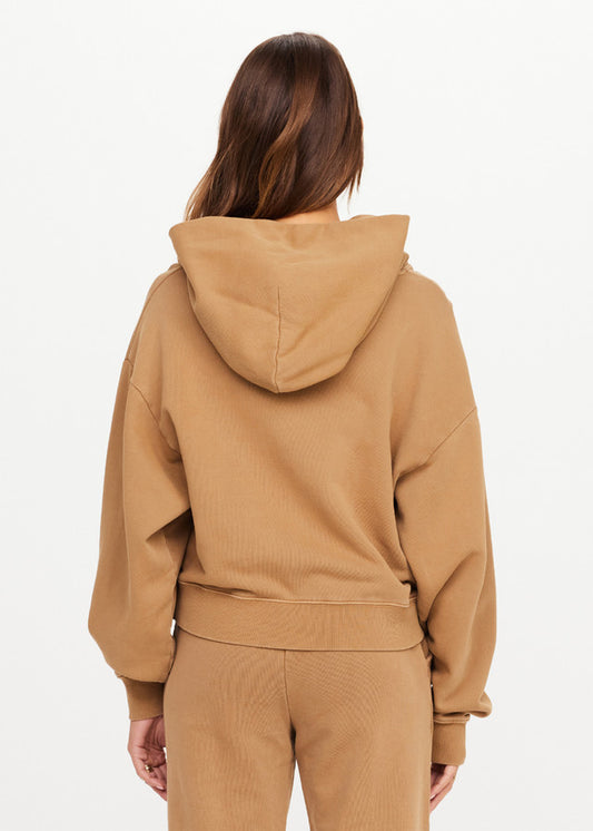 Back view of a person wearing a chai-colored hoodie, cotton material, shown against a white background.