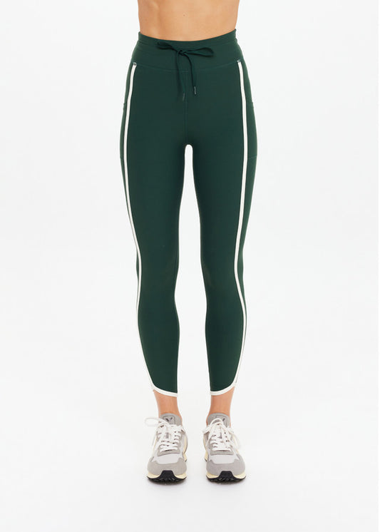 Green midi pants with white side stripes, paired with beige sneakers; suitable for casual or athletic wear.