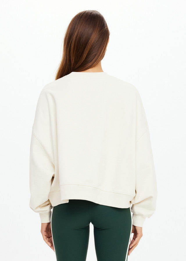 Cream-colored crewneck sweatshirt in soft fabric, modeled from the back against a white background.