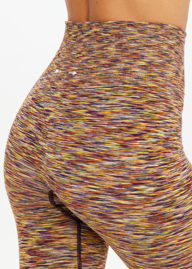 Seamless 25in Daisy Midi Pant in multicolored patterns, highlighting hip and waist area; ideal for activewear.